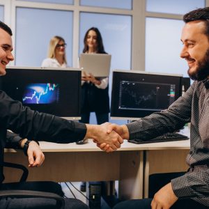 Workers at an IT company working on a computer